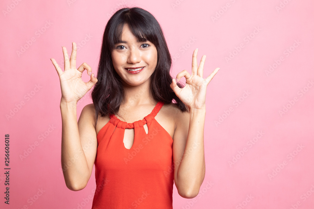 Asian woman show double OK hand sign and smile. Asian woman show double OK hand sign and smile.