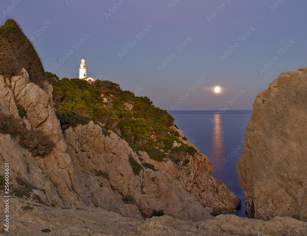 Lighthouse Far de capdepera, dusk, moonbeam on sea,rocks and trees, cala ratjada, mallorca, spain.