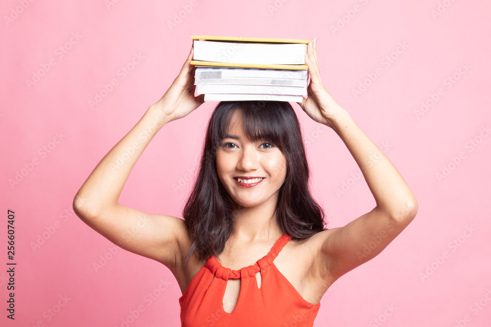 Young Asian woman studying with may books. Young Asian woman studying with may books.