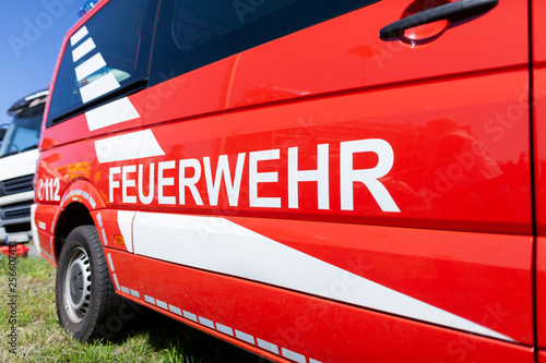 German fire engine stands on a deployment site. The german word Feuerwehr means fire department.