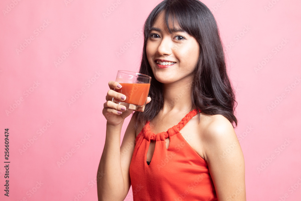 Young Asian woman drink tomato juice. Young Asian woman drink tomato juice.