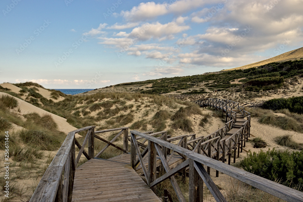 Wooden walkway with sea, sand dunes, beautiful sky and hills, cala mesquida, mallorca, spain. Wooden walkway with sea, sand dunes, beautiful sky and hills, cala mesquida, mallorca, spain.