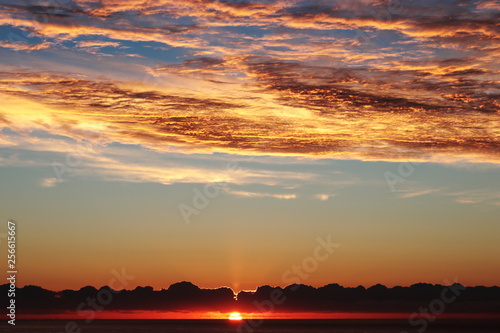 Sunrise cala millor, red fiery dramatic sky above mediterranean sea, mallorca, spain. © gaz