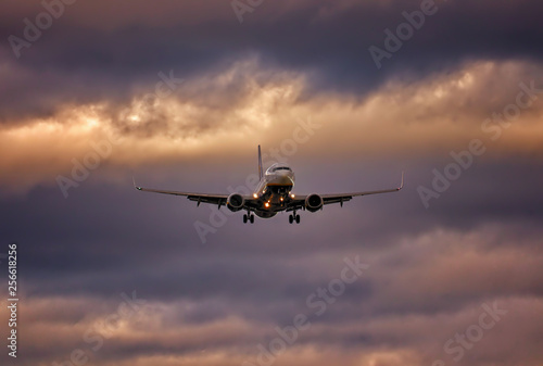 Plane on final approach with wheels down and dramatic sky, palma airport, mallorca, spain.