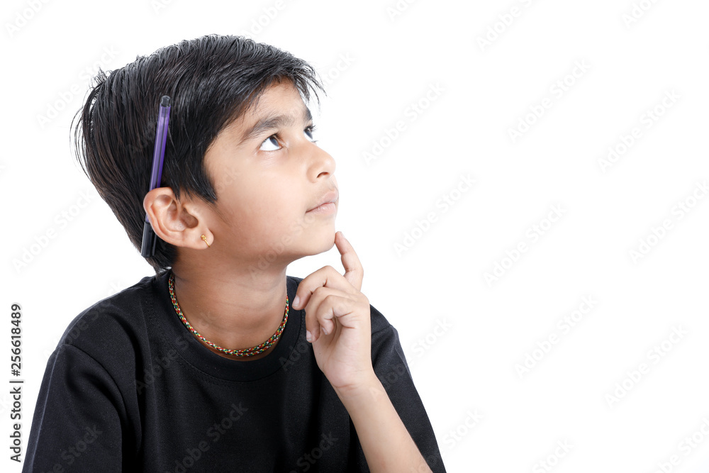 Cute Indian boy thinking idea and looking at up, isolated on white background Cute Indian boy thinking idea and looking at up, isolated on white background
