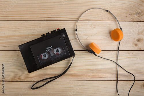 Old portable cassette player on a wooden background photo