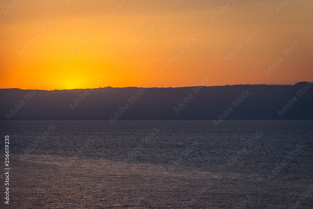 Sunset over Dead Sea salt lake seen from a Jordanian shore