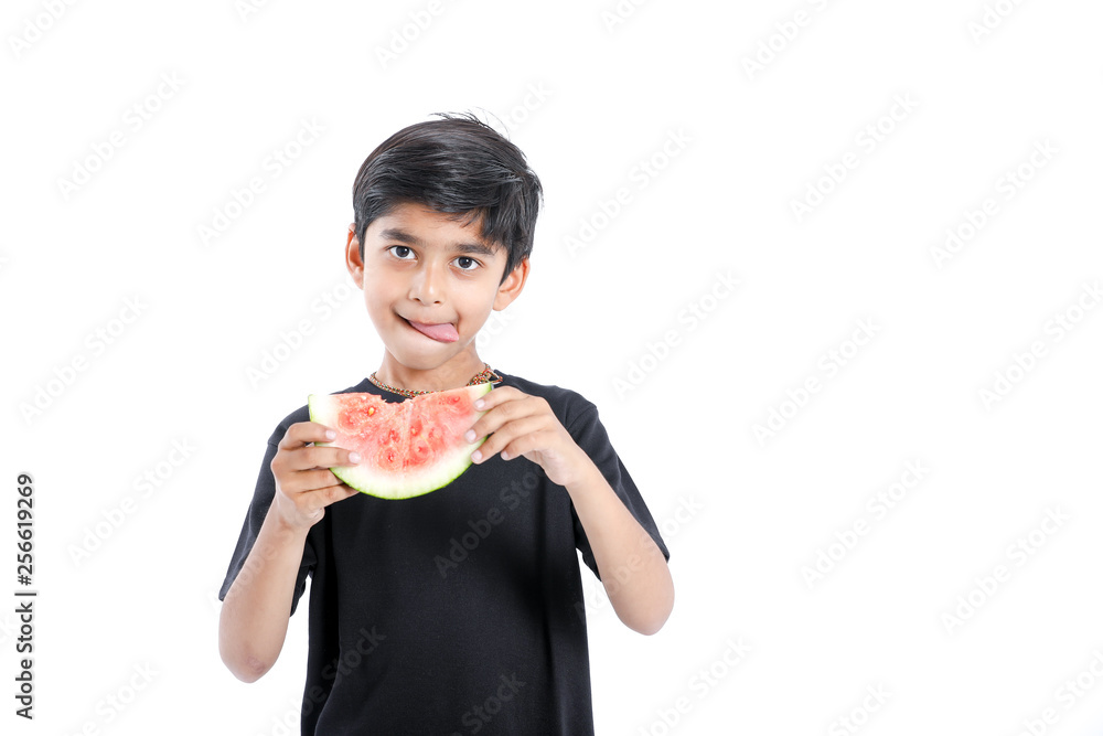 little Indian boy eating watermelon with multiple expressions little Indian boy eating watermelon with multiple expressions