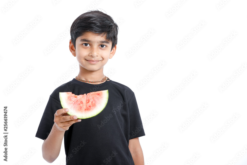 little Indian boy eating watermelon with multiple expressions little Indian boy eating watermelon with multiple expressions