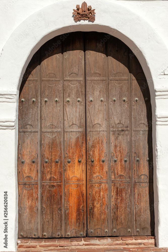 Old wooden front door of Spanish mission Basilica San Diego de Alcala, California, USA