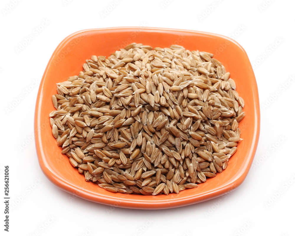 Spelt grains, heap in bowl isolated on white background, macro Spelt grains, heap in bowl isolated on white background, macro