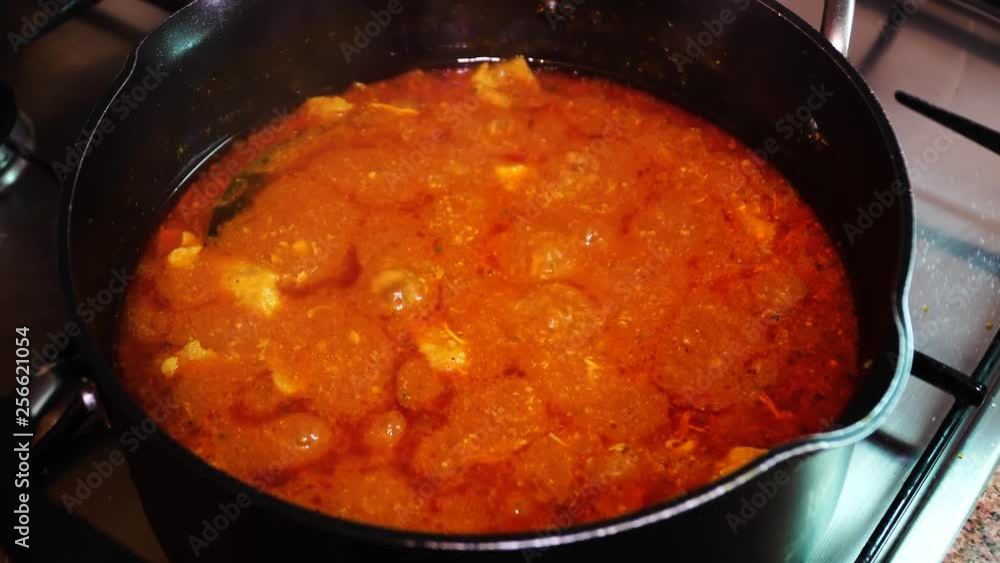 Meat in tomato sauce in a pan of boiling. With onions, tomatoes, paprika, chili pepper, cumin, dill. Hungarian cuisine is goulash. Meat in tomato sauce in a pan of boiling. With onions, tomatoes, paprika, chili pepper, cumin, dill. Hungarian cuisine is goulash.