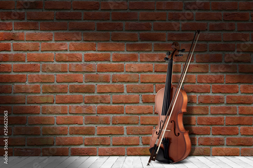 Vintage antique violin near brick wall background. © YB