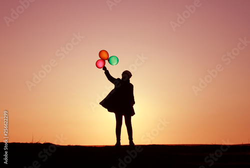girl with balloons at sunset, colorful balloons, incredible sky sunset
