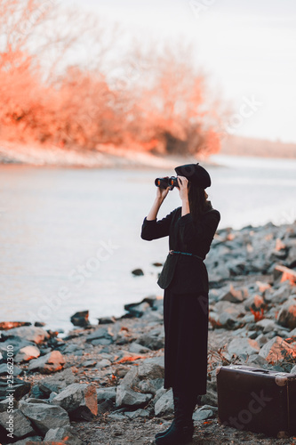Woman in vintage dress and binocular