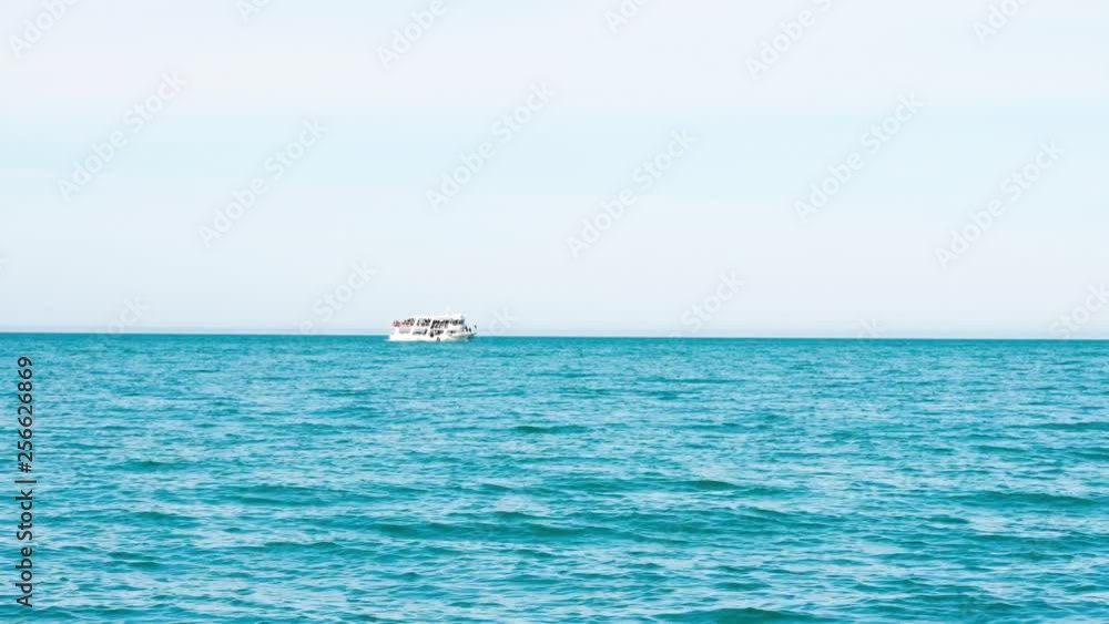 White yacht in the ocean moves from left to right side White yacht in the ocean moves from left to right side