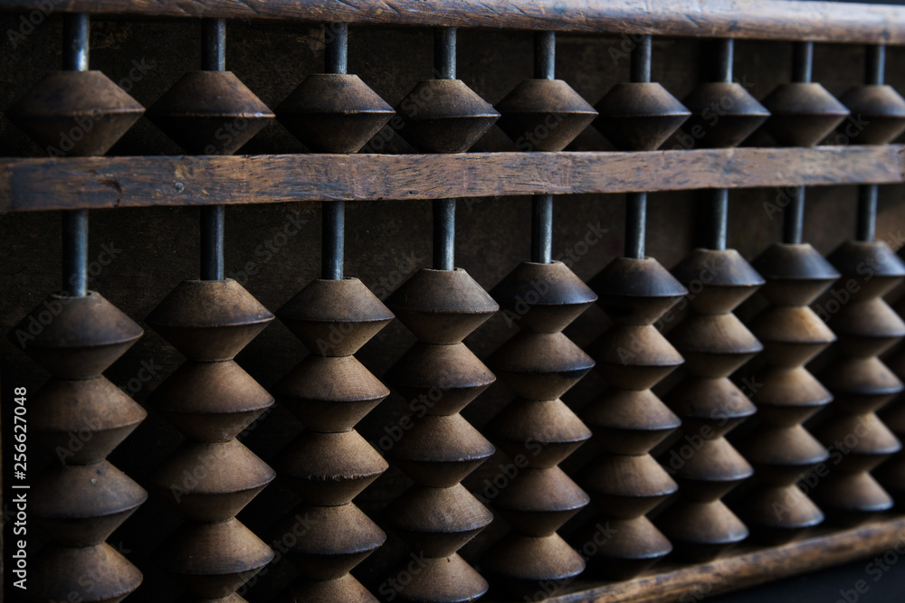 Close up wooden Chinese abacus in dark environment Close up wooden Chinese abacus in dark environment