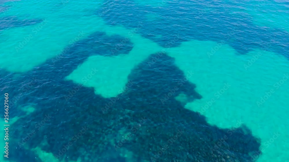Aerial view of blue sea surface with light reflections. Top view of transparent turquoise ocean water surface. Aerial view of blue sea surface with light reflections. Top view of transparent turquoise ocean water surface.