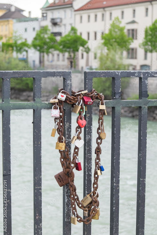Locks and chain on bridge, tourist couple traditional way to show their love Locks and chain on bridge, tourist couple traditional way to show their love
