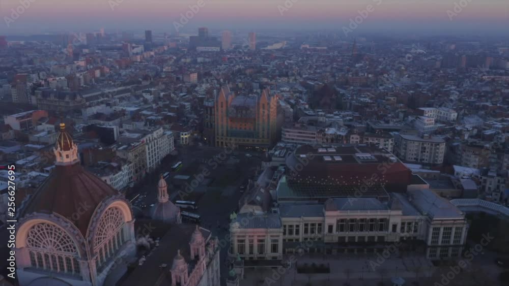 Video shows the beautiful train station in Antwerp with sunrise background. The sky orange sky