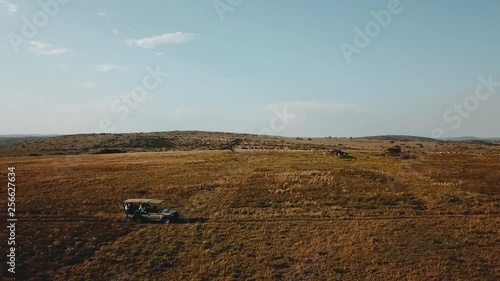 A beautiful cinematic drone shot taken in South Africa while on a safari. There resides a beautiful manor in the middle of a game reserve surrounded by lions, giraffes, elephants, and other animals. photo