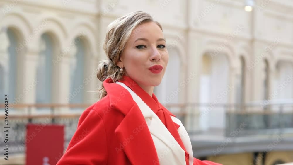 Young confident business woman in red looking at camera and smiling Young confident business woman in red looking at camera and smiling