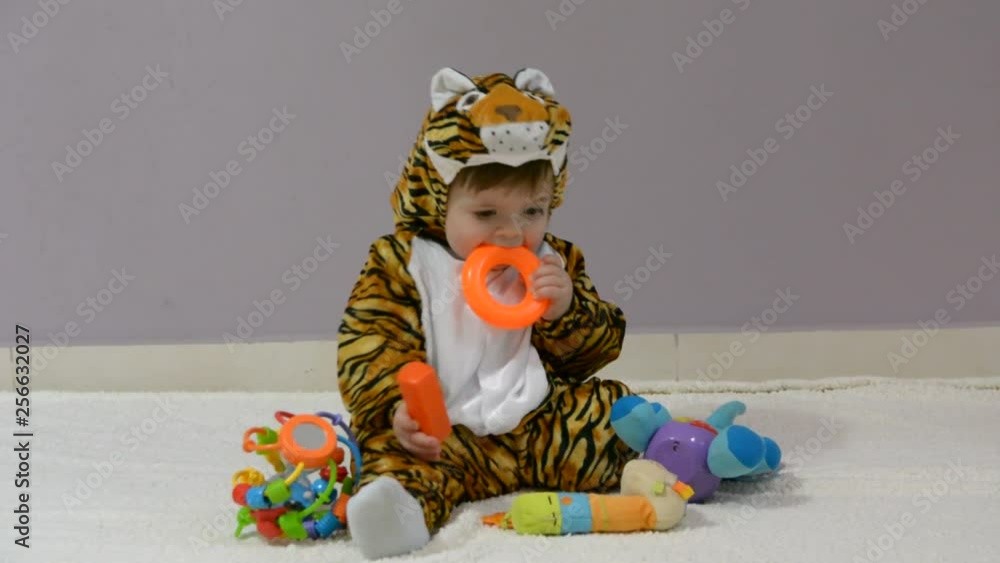 little boy in tiger costume playing with toys little boy in tiger costume playing with toys