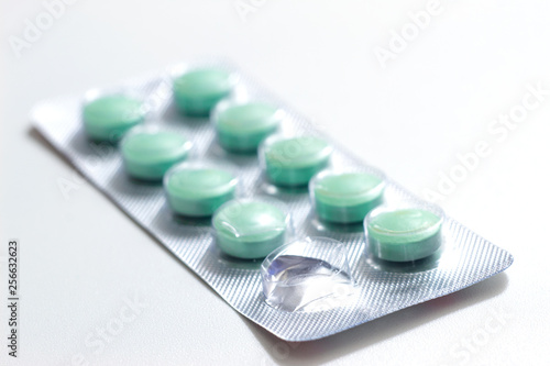 Packs of green pills on white background