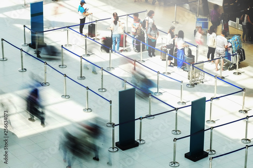 Abstract motion blurred image of people at the airport walking in line to their check in or departure gate