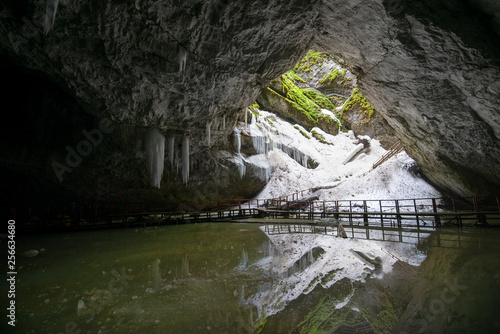 Underground glacier in Glaciers Cave in Apuseni mountains, Scarisoara, Romania. Big icicles holding on ceiling in the cave photo