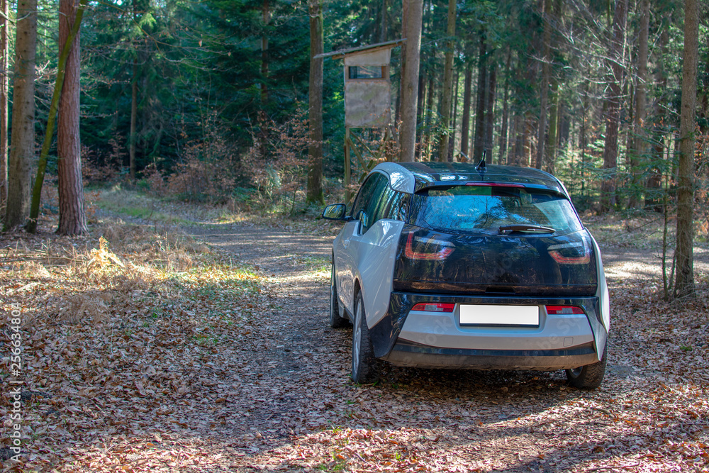 an electric car in the middle of the woods an electric car in the middle of the woods