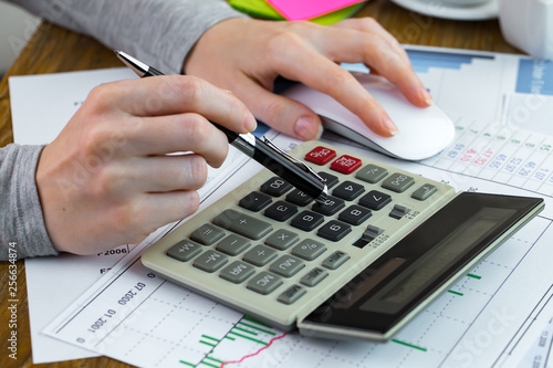 Woman's hands with items for doing business in the office