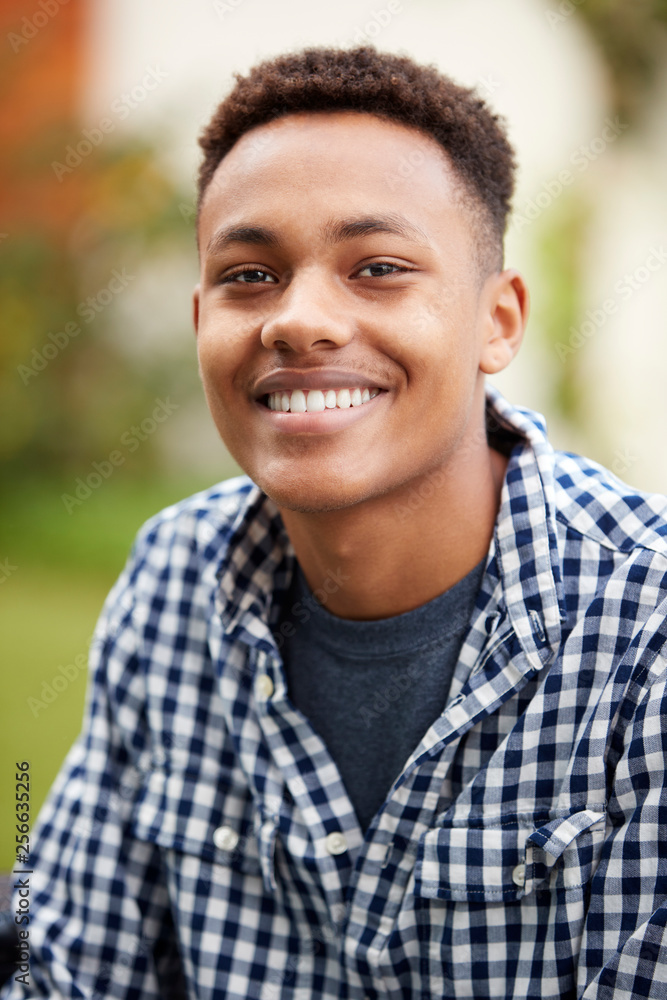 Young black man outdoors smiles to camera, close up, vertical Young black man outdoors smiles to camera, close up, vertical