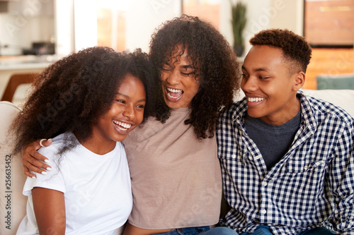 Obraz na plátně Black teen and young adult brother and sisters relaxing together, close up