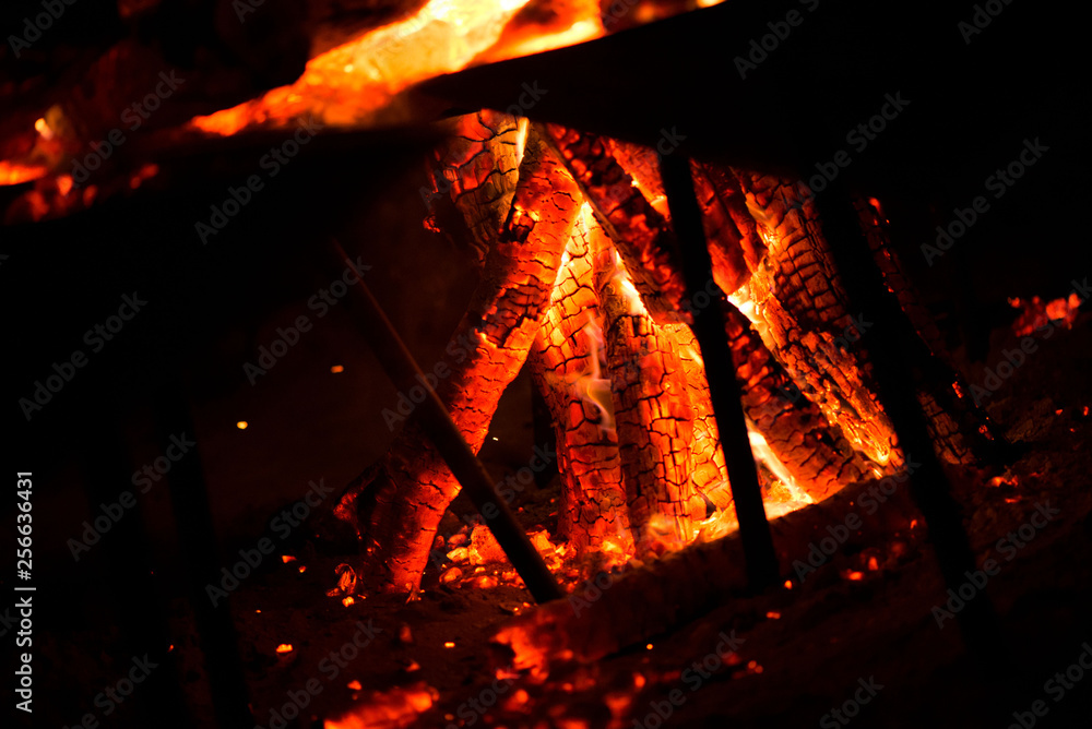 Ignite the fire. Warming up the cold winter nights. A macro shot of firewood, white dust and hot, glowing coal. Burning branches and wood. Flames in the fireplace, cozy home, warmth, love, romantic Ignite the fire. Warming up the cold winter nights. A macro shot of firewood, white dust and hot, glowing coal. Burning branches and wood. Flames in the fireplace, cozy home, warmth, love, romantic
