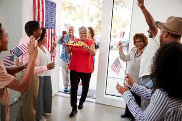 Black family arriving for an Independence Day house party with their relatives