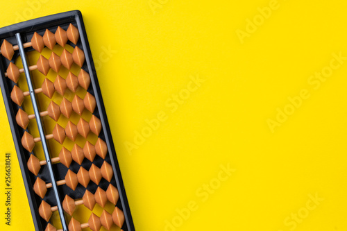 Photos Small abacus mathematic toy on vivid yellow background with copy space, math, fi