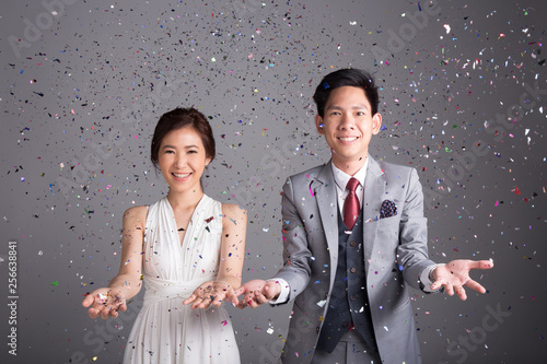 Couple throw glittering paper to celebrate their wedding
