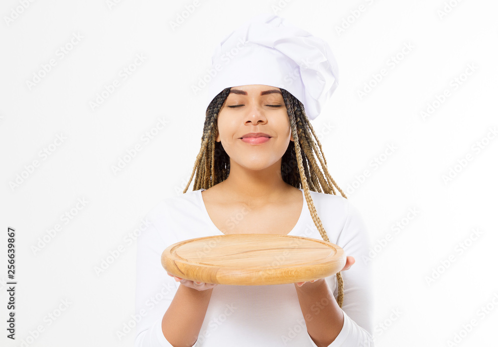 Young attractive african american woman in cooking hat holding empty wood pizza cutting board isolated on white background. Copy space and mock up. Blank template background. Top view Young attractive african american woman in cooking hat holding empty wood pizza cutting board isolated on white background. Copy space and mock up. Blank template background. Top view
