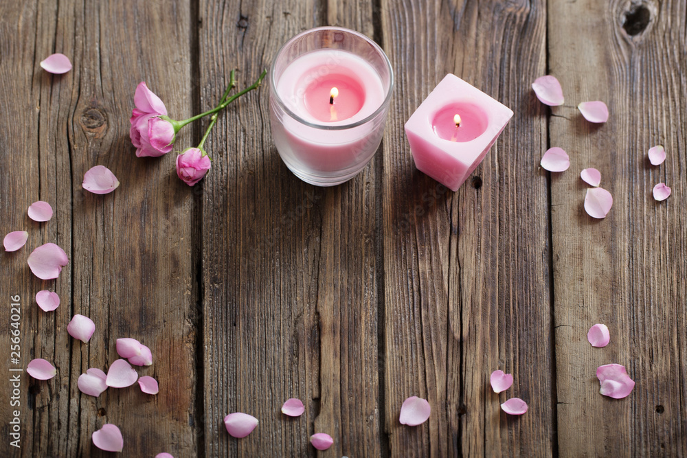 candles and roses on wooden background candles and roses on wooden background