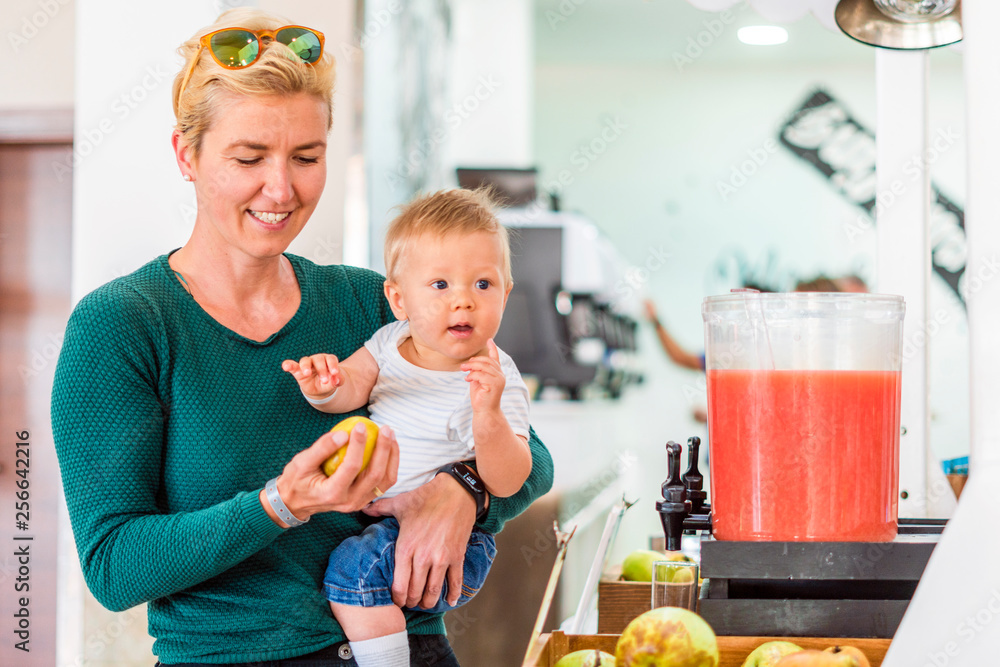Mother with baby boy and apple in all inclusive restaurant Mother with baby boy and apple in all inclusive restaurant