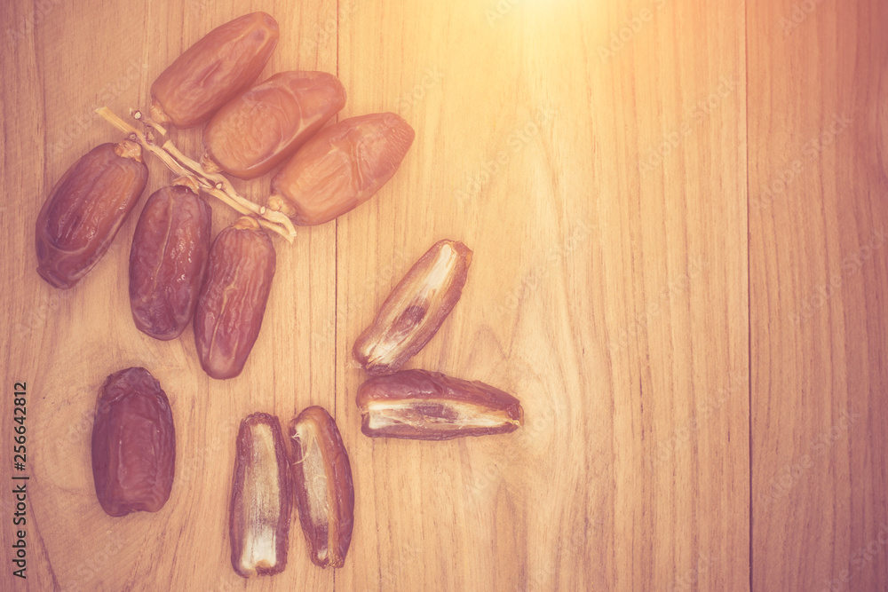 Close up fruits of date palm on wood background,fresh date-palm and dry date-palm on rustic wooden Close up fruits of date palm on wood background,fresh date-palm and dry date-palm on rustic wooden