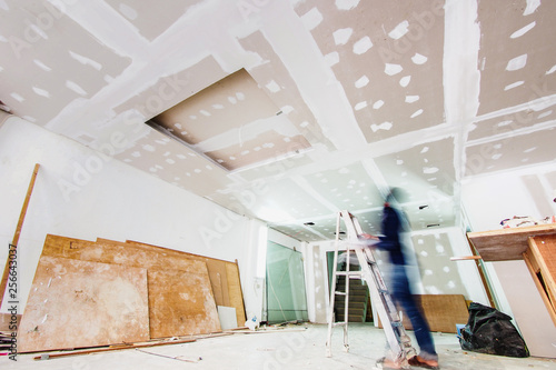 Interior worker working on the ceiling, shot with slow speed shutter