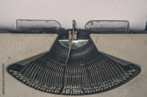 Close up photography of old typewriter typing on blank paper, space for text