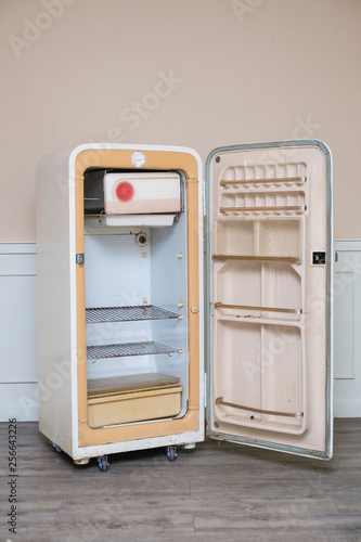 Old vintage open empty refrigerator