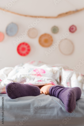 Female feet in warm wool socks, Woman Sleeping and Relaxing in bed