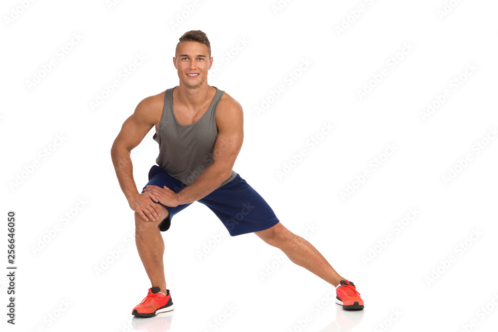 Young Man Stands Apart, Warms Up And Stretches