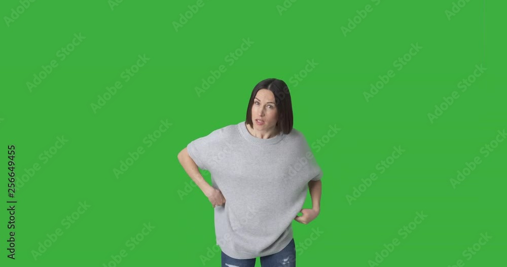 Young woman having an argument against green chroma key background Young woman having an argument against green chroma key background