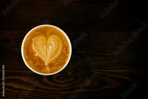 Cup of cappuccino coffee with heart shape latte art on old wood table Background, Latte coffee on old wooden Background table