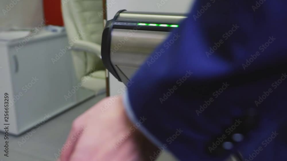 closeup worker uses contactless key for passing to office closeup worker uses contactless key for passing to office